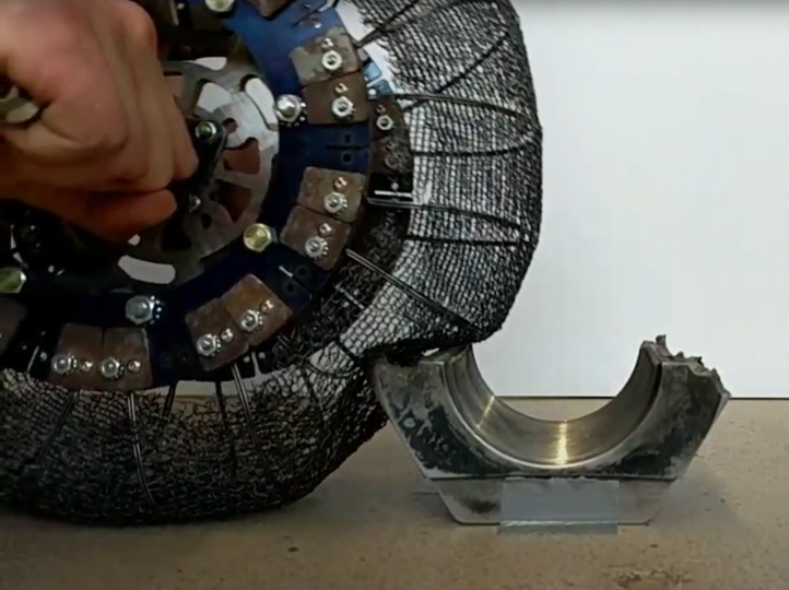 Demonstration of rover tire deforming around an obstacle